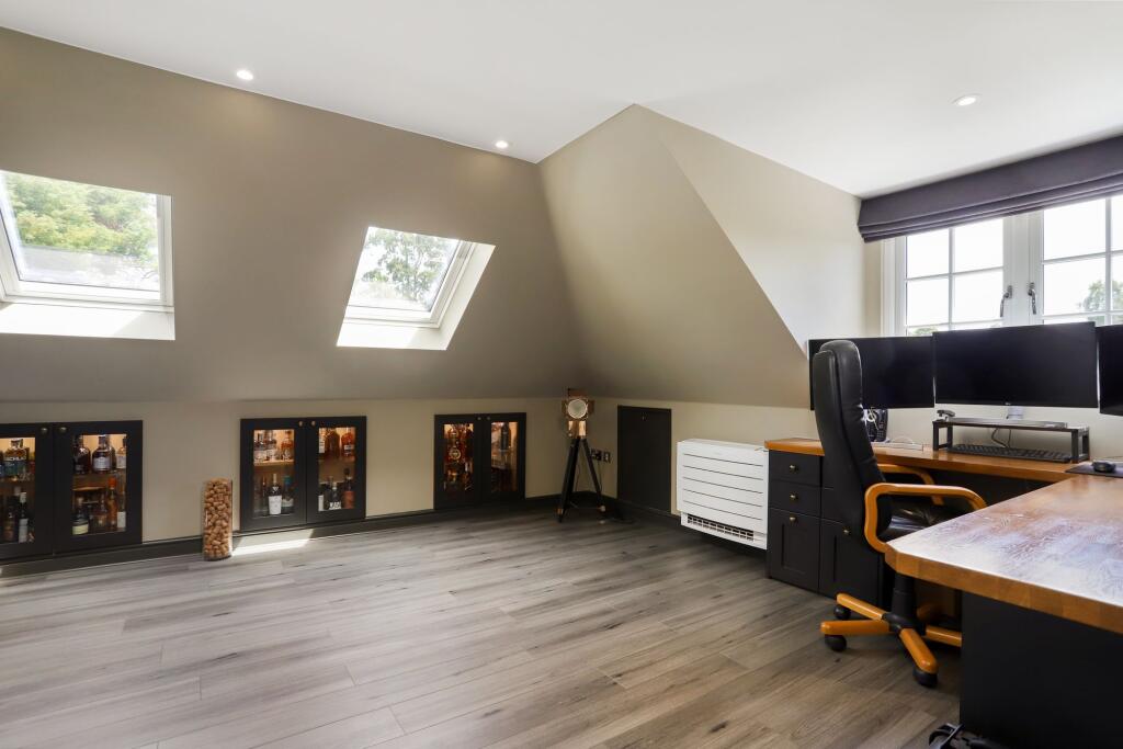 5 kilowatt floor mounted ac unit in stoke poges loft office room with sloped ceilings
