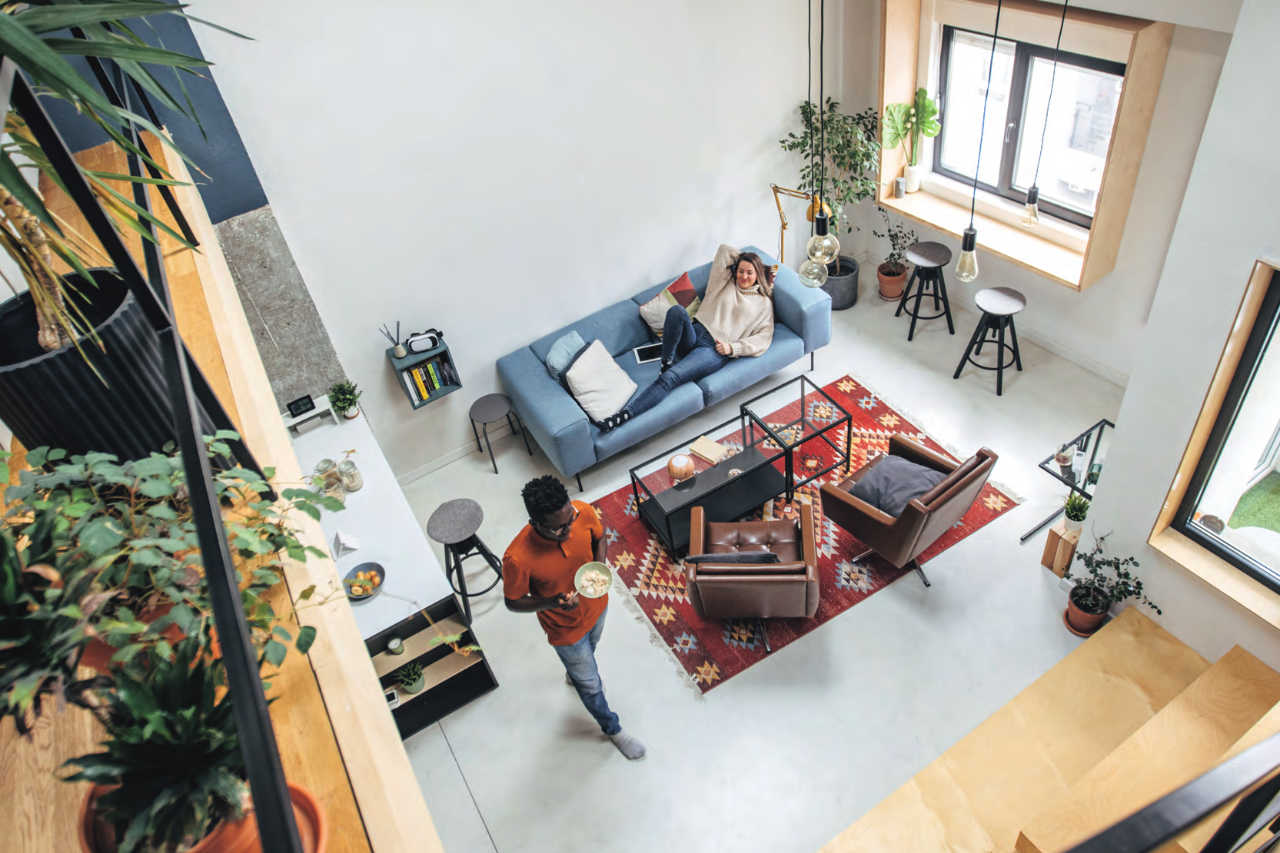 Couple in modern living room enjoying their perfect indoor climate
